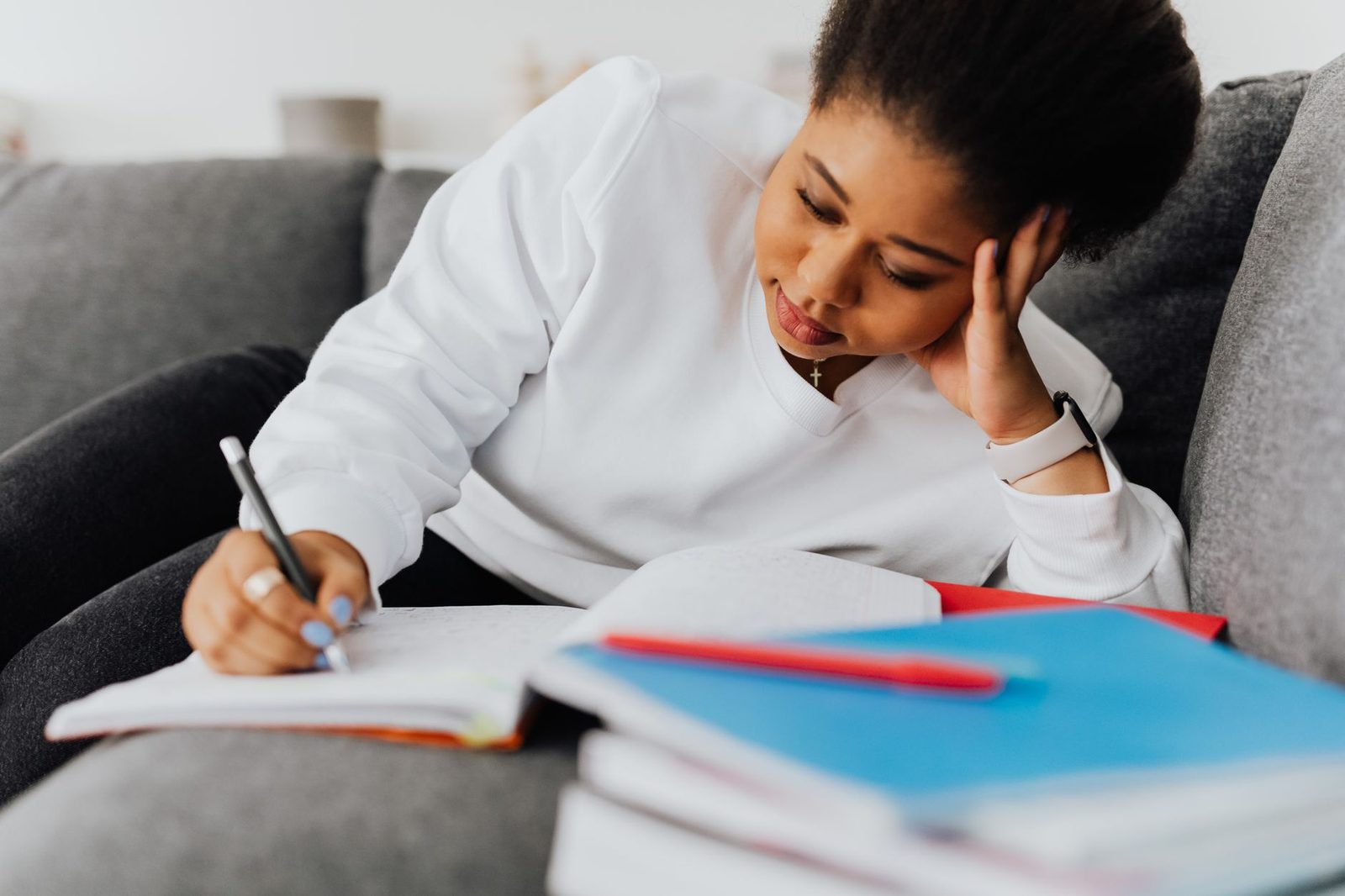 Student writing a college application essay at a desk