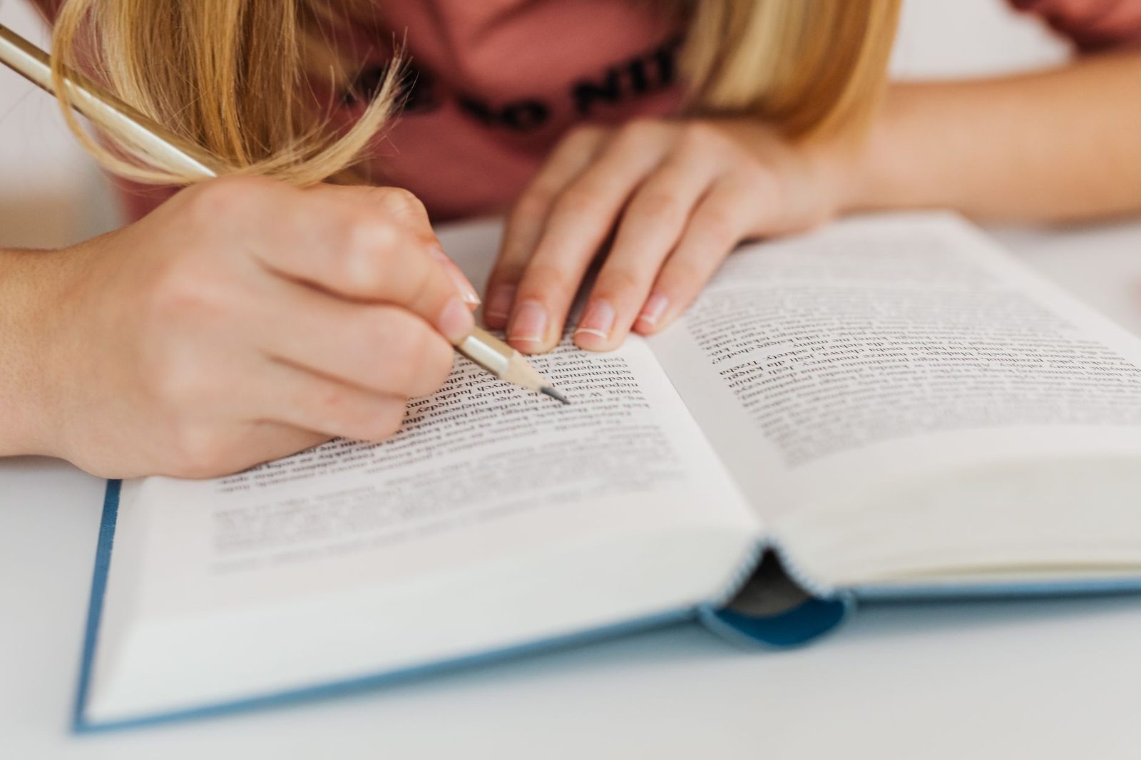 Student reviewing and marking up a printed draft at a desk